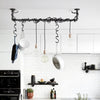 Ceiling mounted dark iron rail used to hang pots and pans and a lot of light blubs functional design